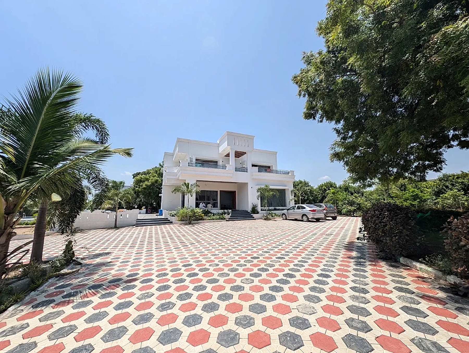 Green Enclaves Farm & Resort real contemporary two-story white villa and paved courtyard